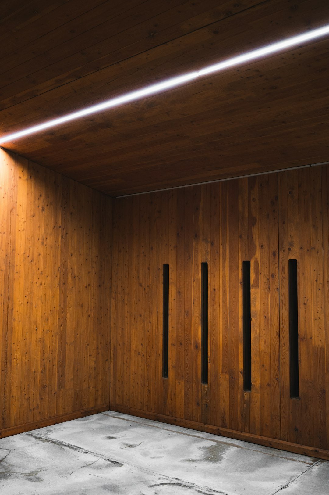 services-01 a-room-with-wooden-walls-and-a-concrete-floor-5mytqtjh5nc